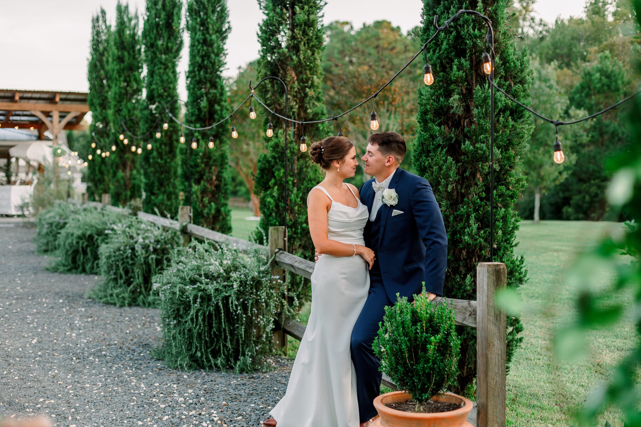 bride and groom wedding dress standing in courtyard