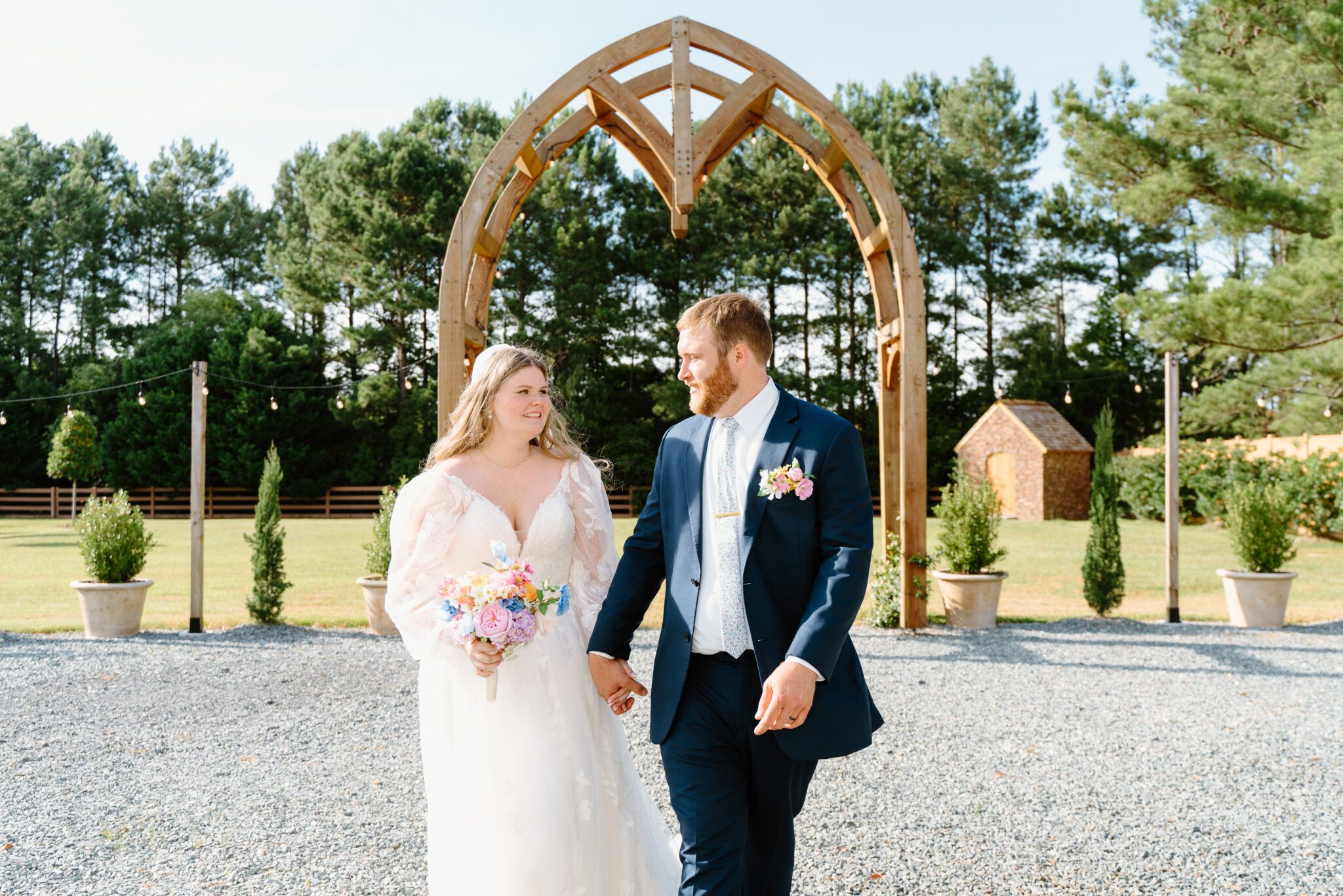bride and groom wedding ceremony arbor