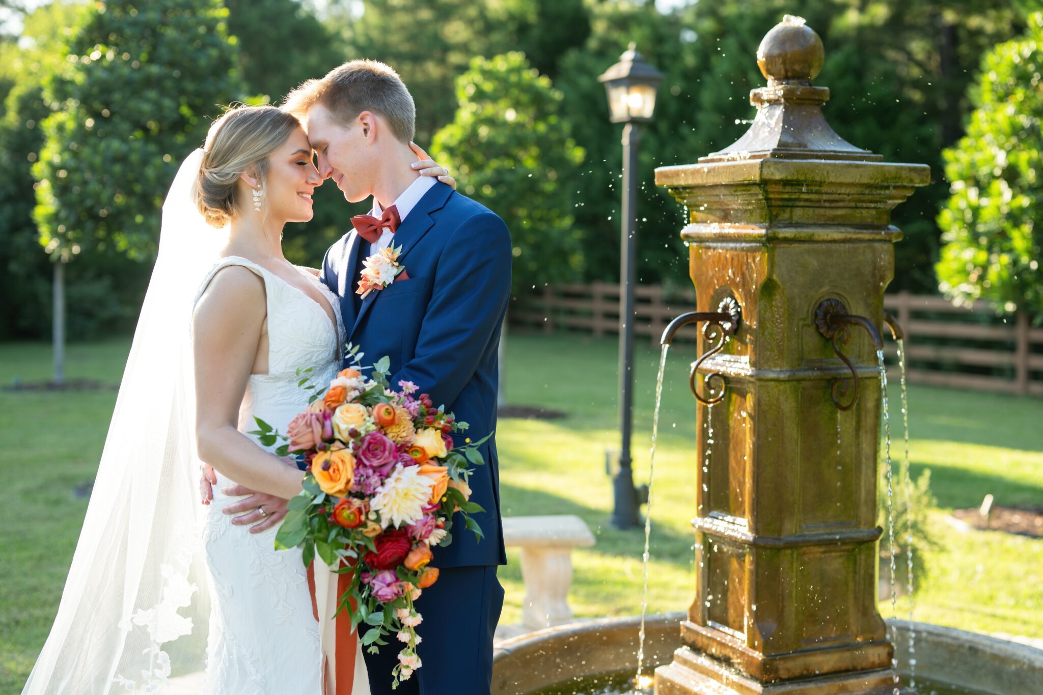 bride and groom standing at European water fountain